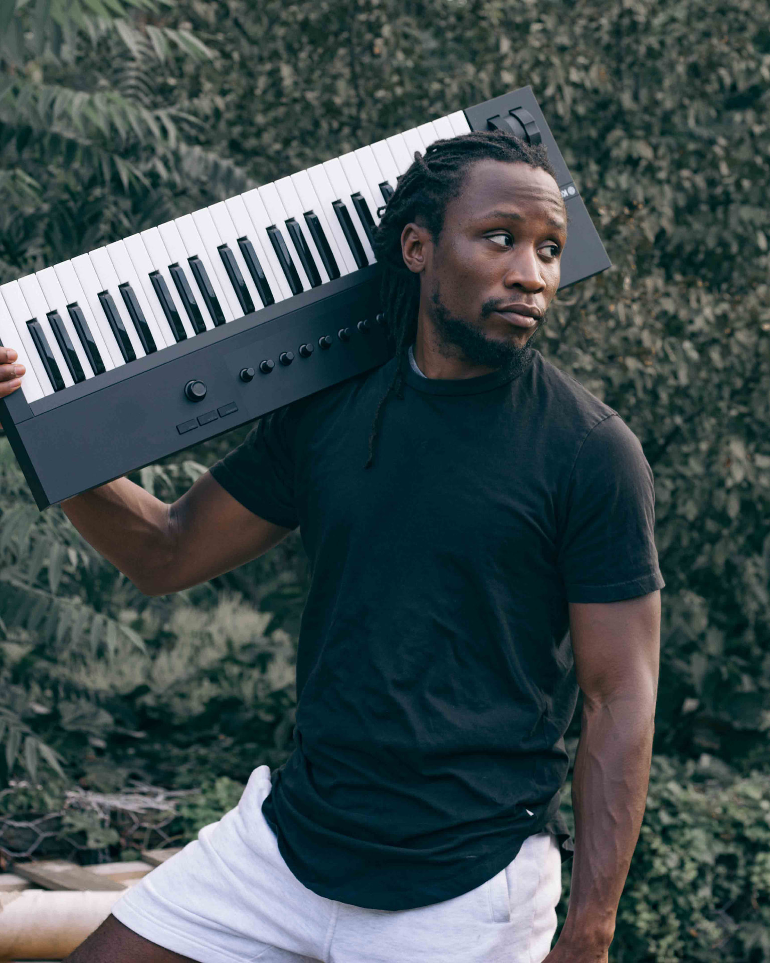 Melvin Darrell, founder of Sound Patch, holding a keyboard outdoors